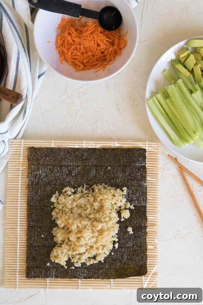 Crafting Vibrant Veggie Quinoa Sushi 8 A bamboo mat wrapped in plastic wrap, ready for making sushi.