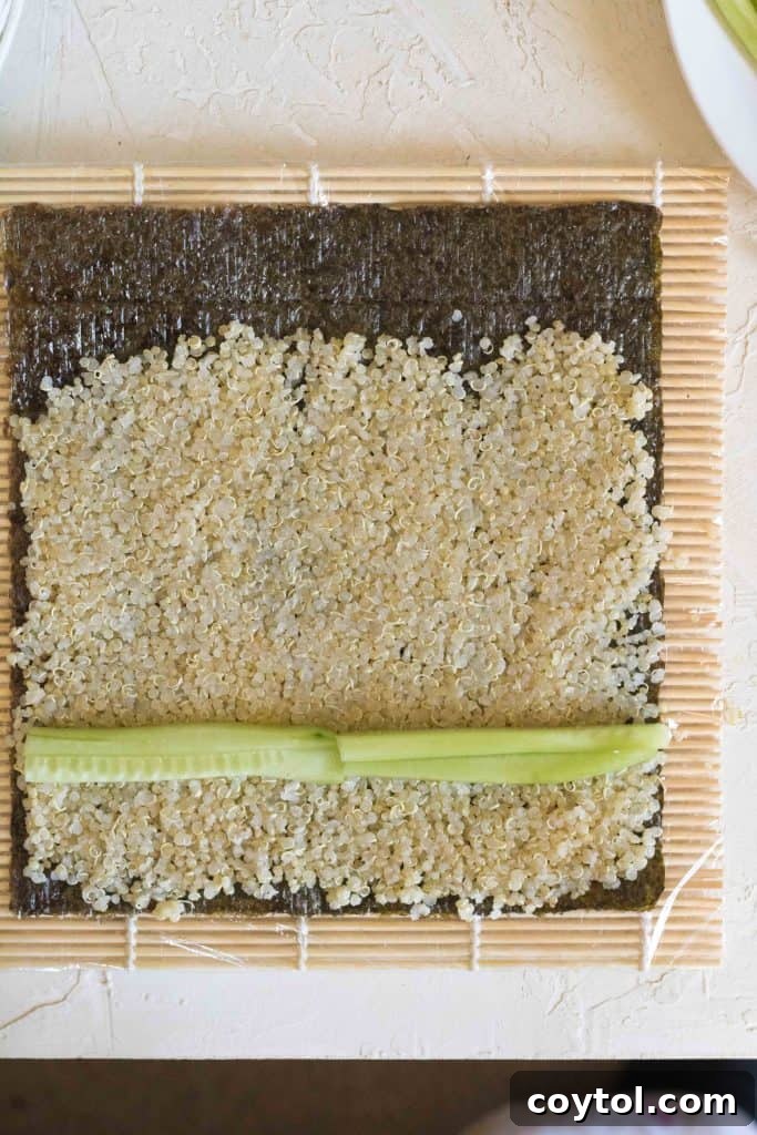 Crafting Vibrant Veggie Quinoa Sushi 10 Adding more cucumber and other vegetables to the quinoa sushi roll.