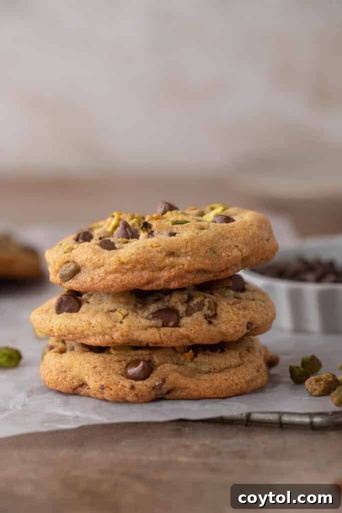 Decadent Brown Butter Pistachio Chocolate Chip Cookies 4 A stack of golden brown butter pistachio chocolate chip cookies, showcasing their inviting texture and generous mix-ins.