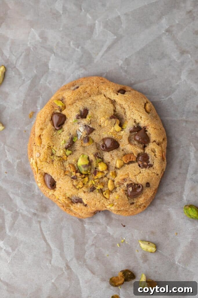 Decadent Brown Butter Pistachio Chocolate Chip Cookies 9 Freshly baked brown butter pistachio chocolate chip cookies cooling on a wire rack, still warm and gooey.