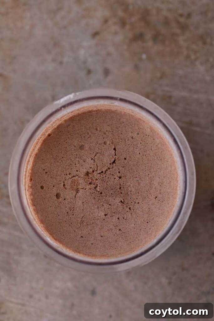 Ninja Creami: The Ultimate Chocolate Experience 6 Frozen chocolate ice cream mixture in a pint
