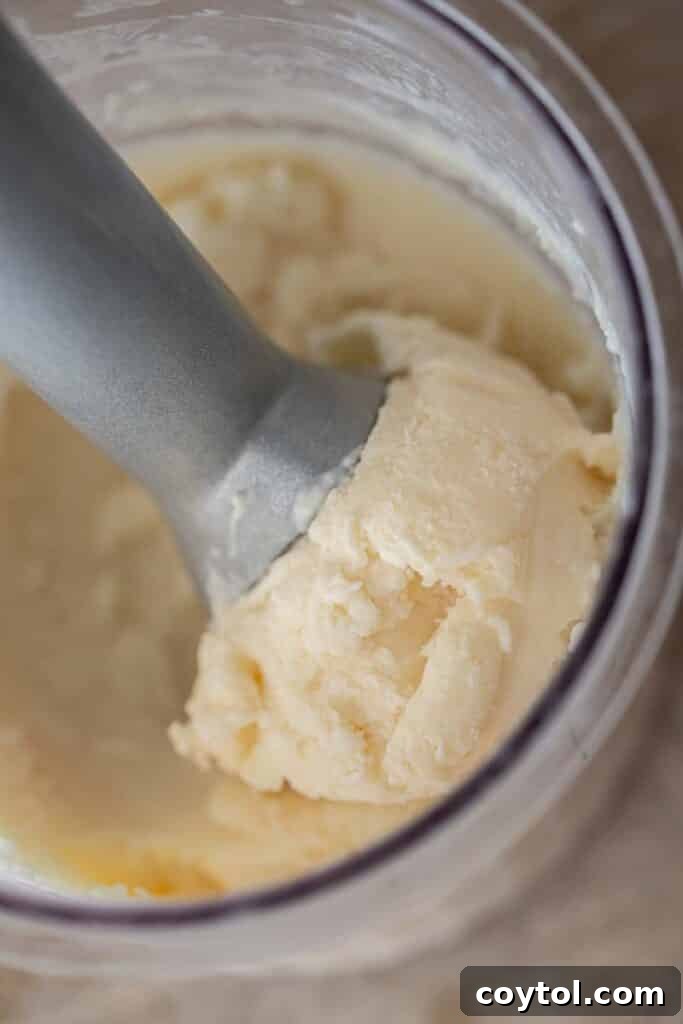 Ninja Creami Vanilla: Your Ultimate Guide to Creamy Bliss 10 Scooping ice cream from the Ninja creami pint