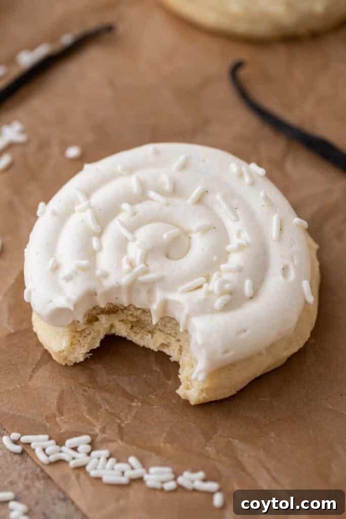 Crumbl Vanilla Bean Cupcake Dream Cookie 2 Crumbl nilla bean cupcake cookie with a bite taken out of it