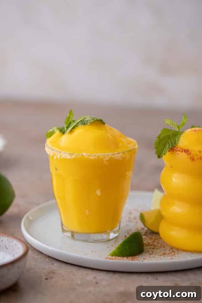 Several frozen mango margaritas in elegant glasses, ready to be served.