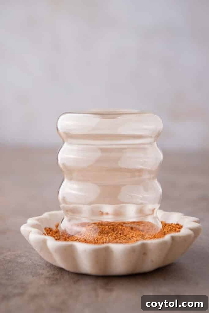 A glass rimmed with Tajín seasoning.