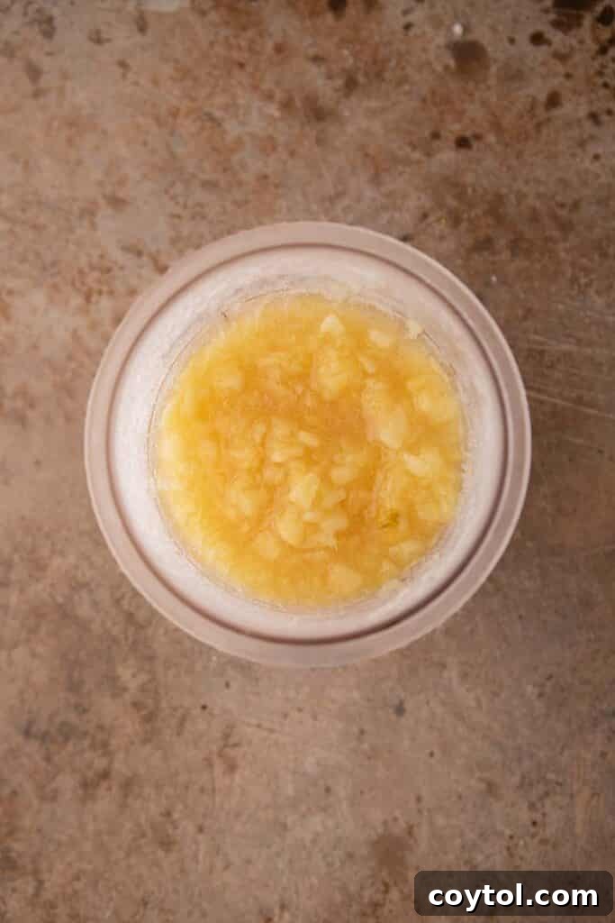 Crushed pineapple and powdered sugar stirred in a Ninja Creami pint cup