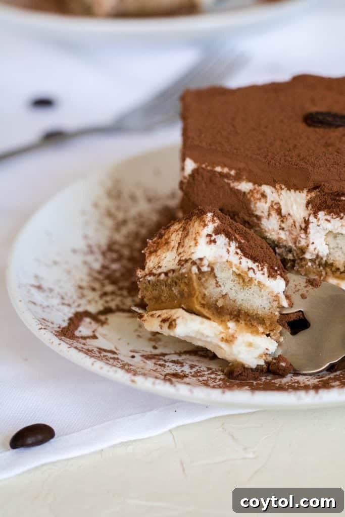 Fork lifting a bite of no-bake tiramisu