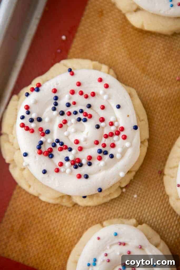 Crumbl All-American Birthday Cake Cookies 11 Close-up of a Crumbl patriotic sugar cookie with frosting and sprinkles