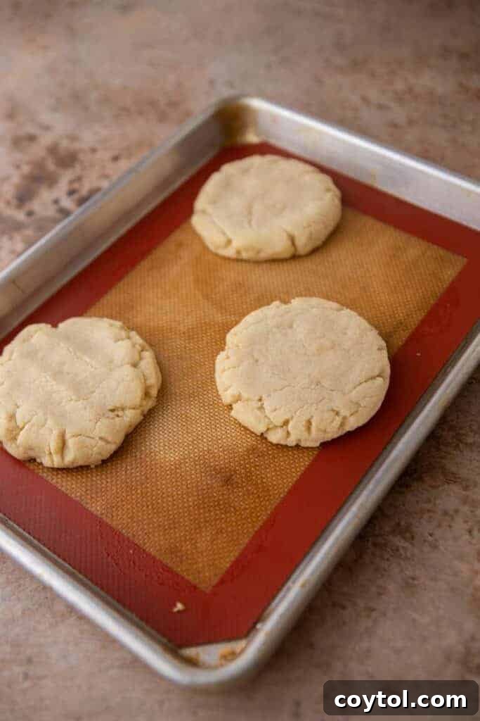 Crumbl All-American Birthday Cake Cookies 10 Freshly baked sugar cookies cooling on a baking pan