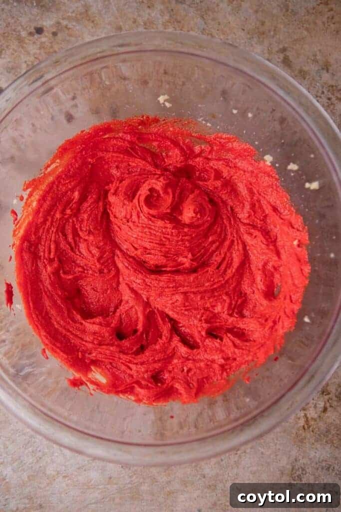 Creamed butter with red food coloring in a bowl