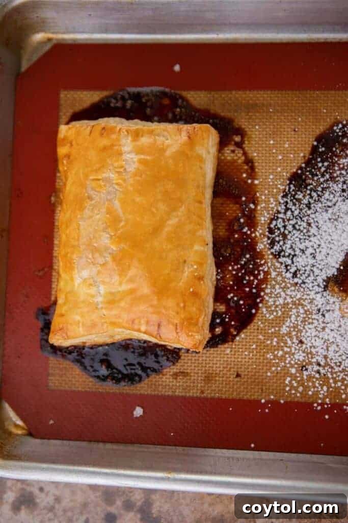 Flip for Flavor: Viral Upside-Down Pastries 8 Baked golden-brown mini tarte tatin pastries cooling on a baking sheet.