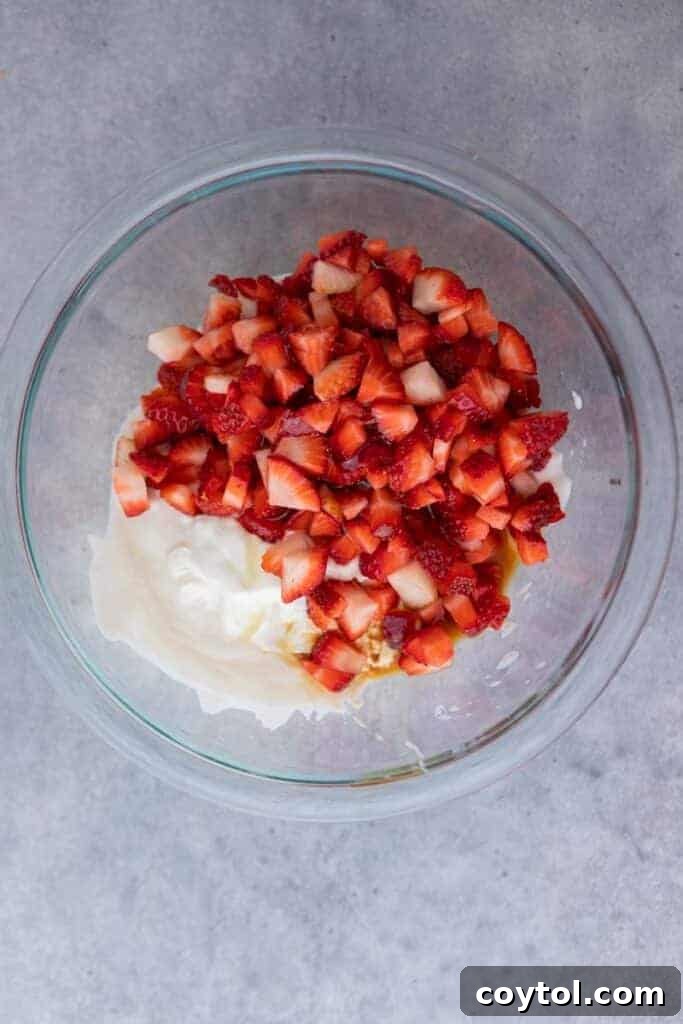 Decadent Chocolate Strawberry Yogurt Bites 5 Diced strawberries and Greek yogurt in a bowl, ready to be mixed for the yogurt clusters