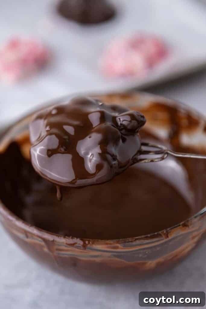 Decadent Chocolate Strawberry Yogurt Bites 10 A chocolate-dipped yogurt cluster placed back on the baking sheet, with sea salt sprinkle, awaiting final freeze