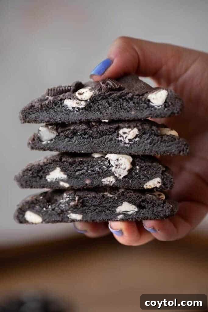 Crumbl Chocolate Cookie Cream Bliss 2 Hand holding stack of delicious Crumbl Chocolate Cookies and Cream Cookies