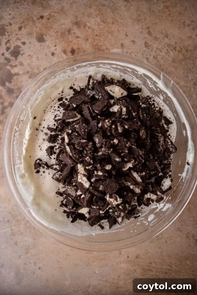 No-Churn Oreo Ice Cream Bliss 6 Whipped cream and sweetened condensed and Oreos milk on a bowl