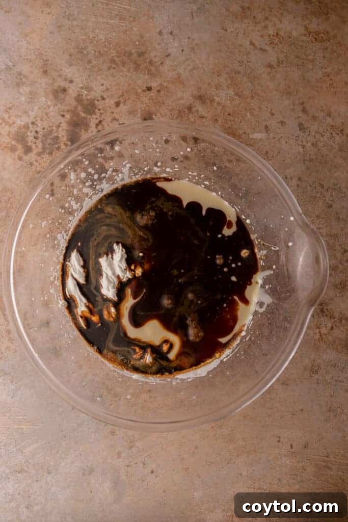 Combining the dissolved coffee mixture with sweetened condensed milk before folding it into the whipped cream.