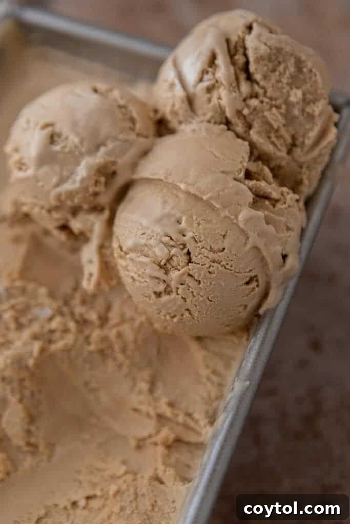 The smooth coffee ice cream base being poured into a loaf pan, ready for freezing.