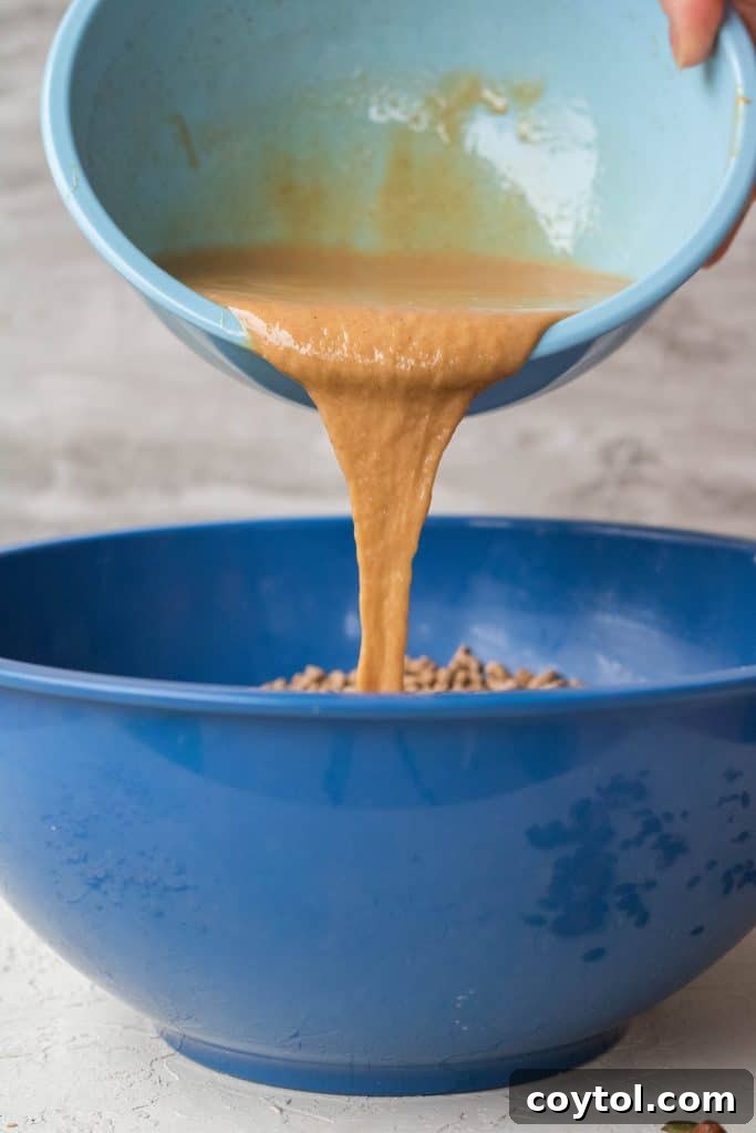 Mixing dry ingredients in a large bowl for homemade energy bars.