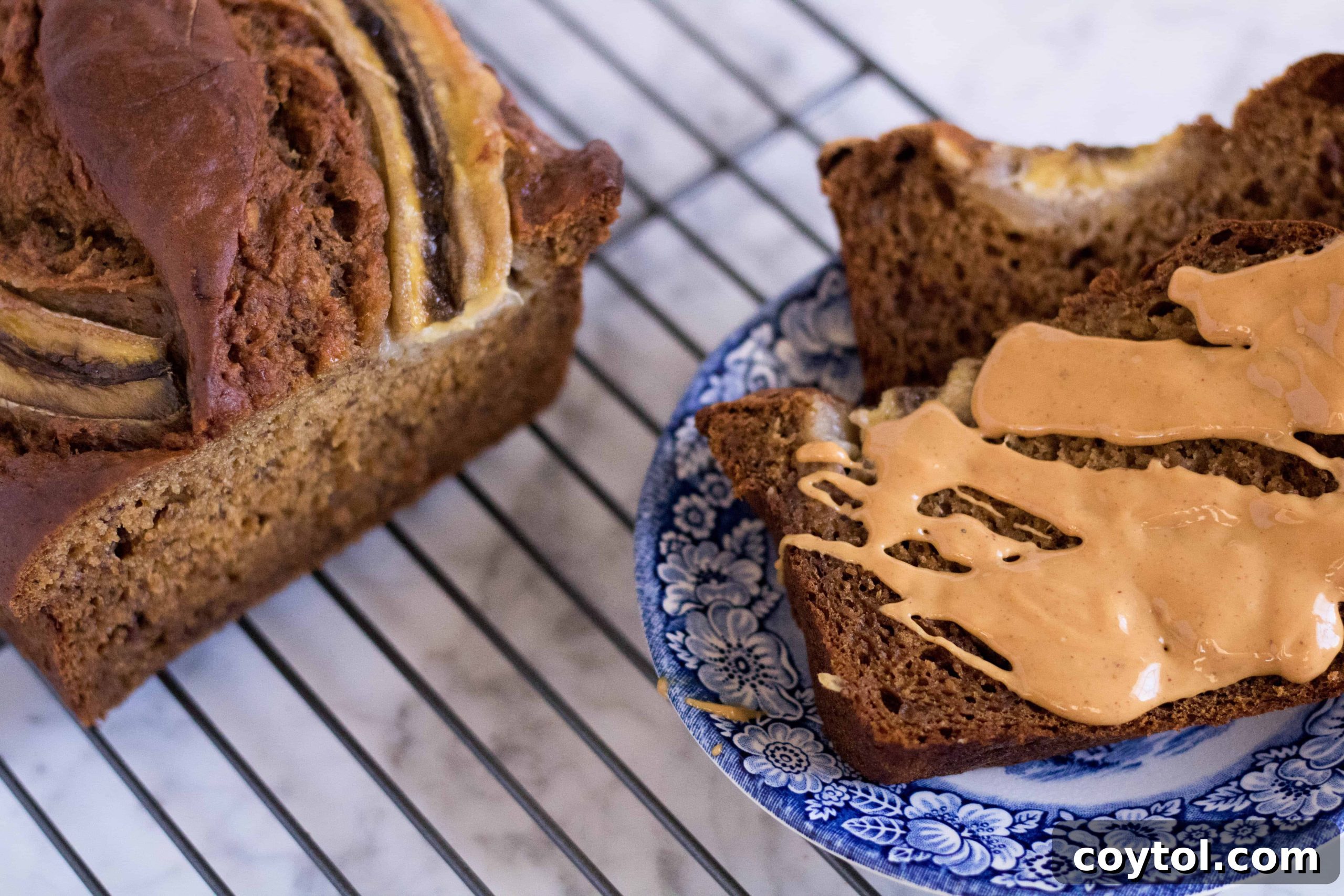 Freshly baked banana bread cooling on a wire rack, showcasing its golden crust