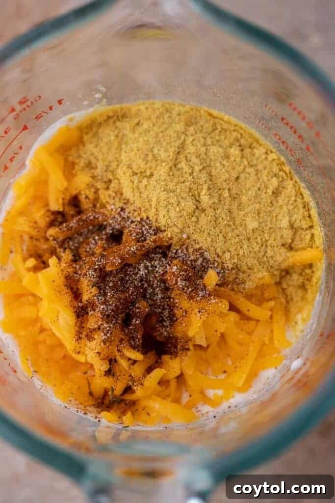 Cottage cheese and other ingredients in a blender, ready to be processed into a smooth mixture.