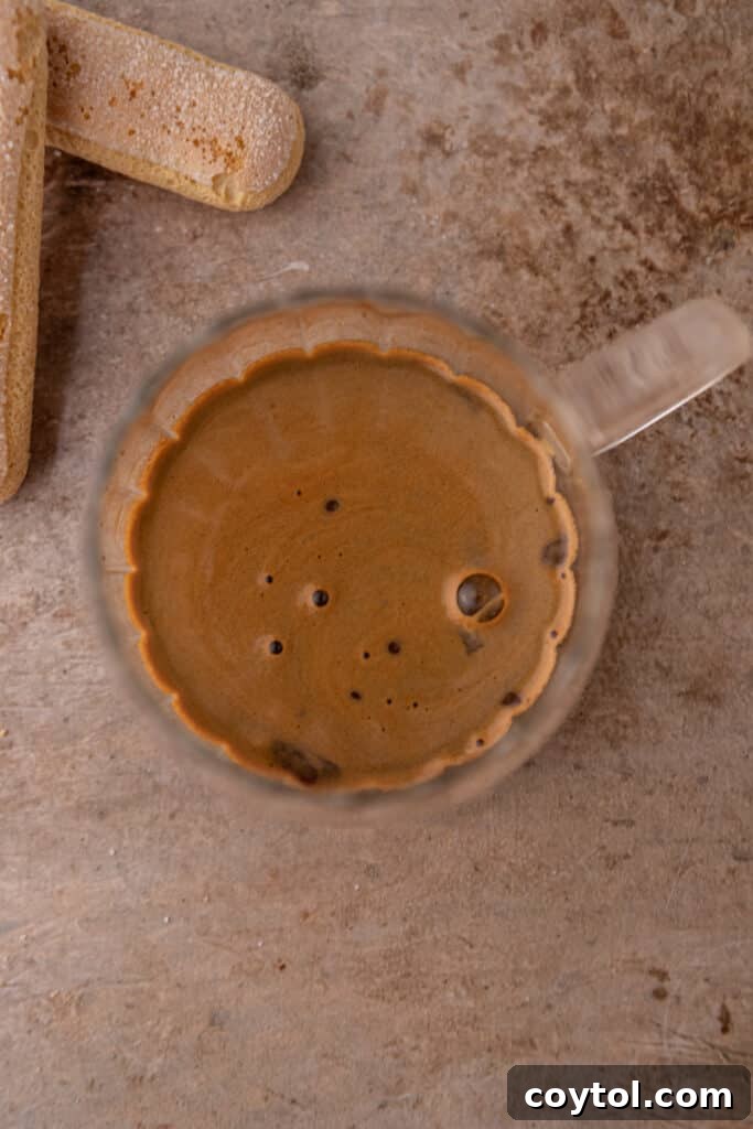 Freshly brewed espresso in a clear cup, showing its rich color.