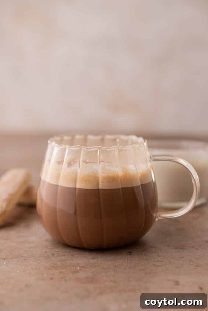 Espresso with steamed milk poured into a cup, forming the latte base.