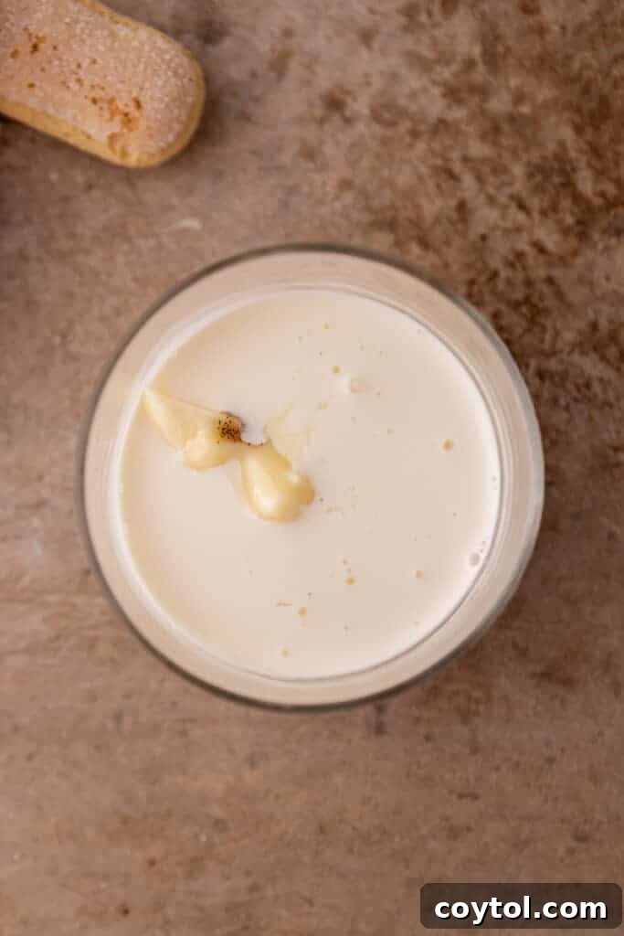 Ingredients for cold foam, including mascarpone and heavy cream, in a measuring cup.