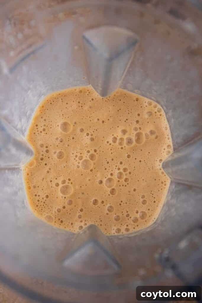 Pumpkin spice frappuccino blending smoothly in a high-speed blender.