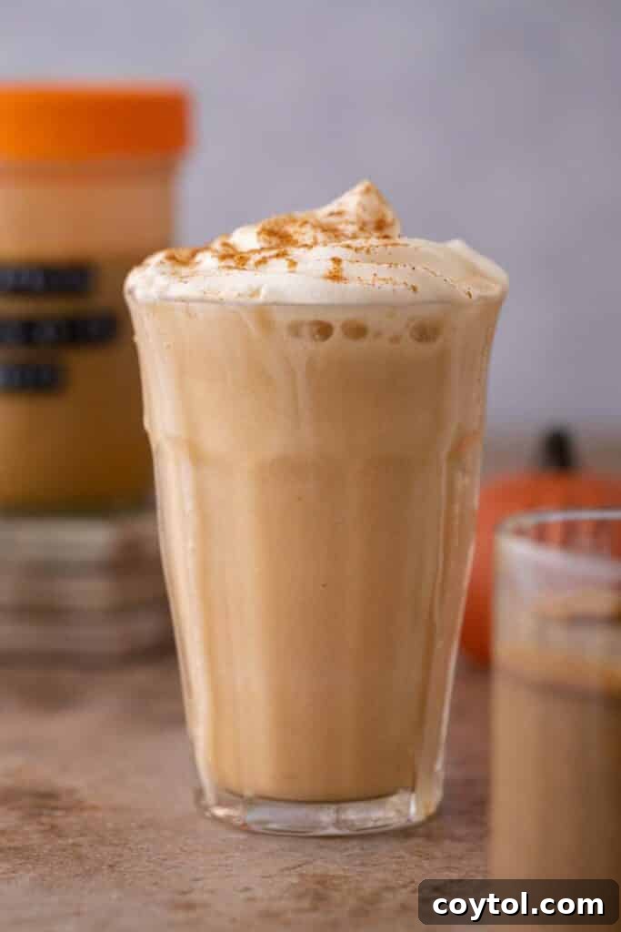 A finished Starbucks Pumpkin Spice Frappuccino in a glass, ready to be served.