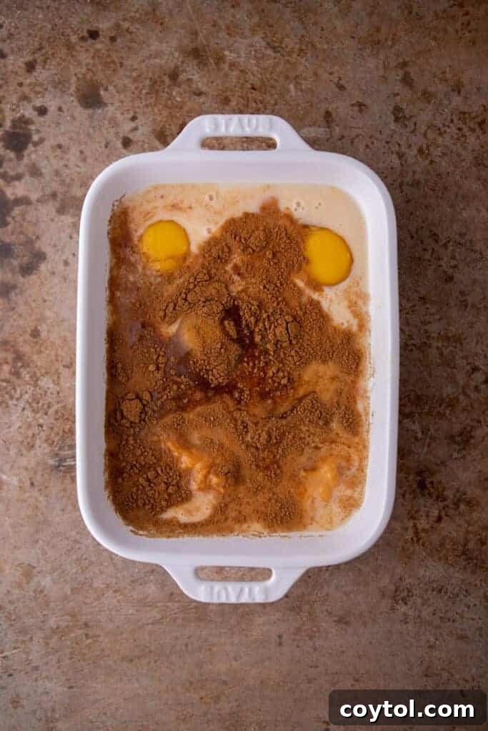 Effortless Pumpkin French Toast Delight 5 A shallow baking dish filled with smooth, spiced pumpkin custard, ready for bread soaking.
