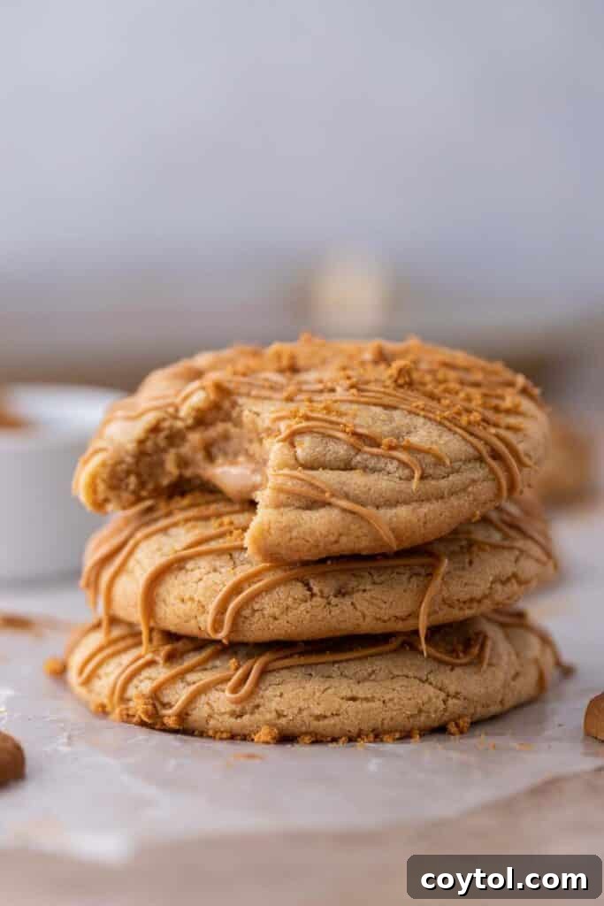 Stacked Crumbl cookie butter lava cookies in a kitchen setting.