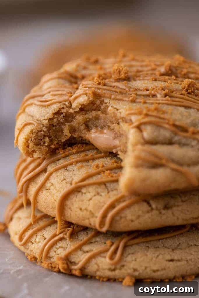 Stacked Crumbl cookie butter lava cookies with a visible gooey center.