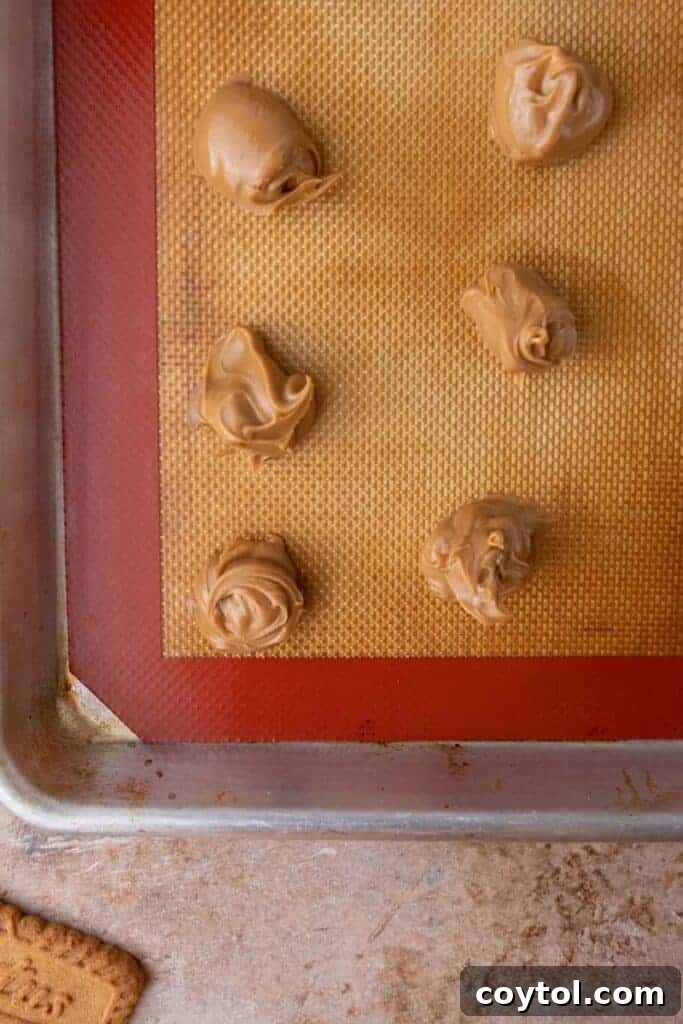 Cookie butter dollops frozen on a baking sheet.
