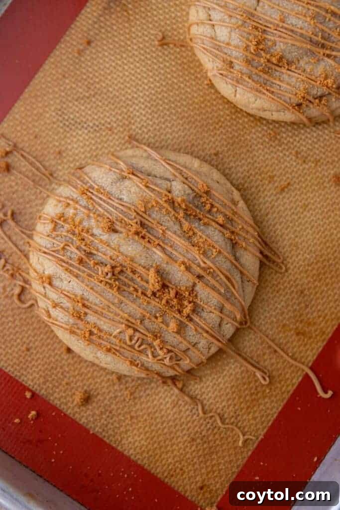 Freshly baked Crumbl cookie butter lava cookie on a baking sheet.