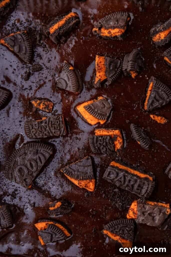 Close-up of Halloween Oreo brownie batter topped with crushed Oreos before baking