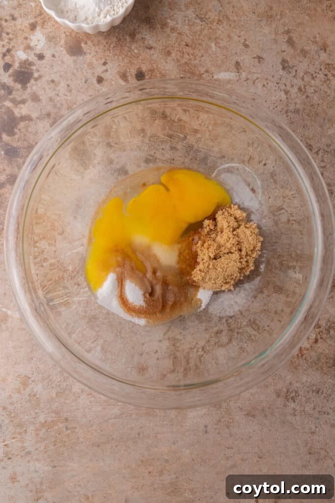 Wet ingredients (melted butter and chocolate) in a glass bowl, ready to be mixed.