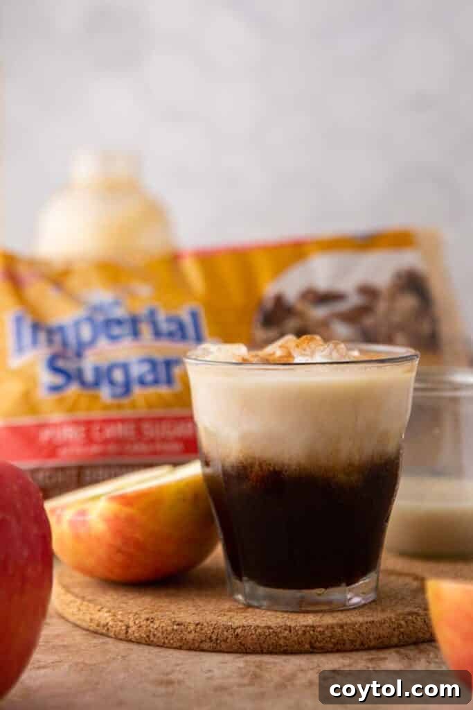 Starbucks Iced Apple Crisp Oatmilk Shaken Espresso 4 A close-up of the Imperial Sugar packaging next to a finished glass of homemade iced apple crisp oatmilk shaken espresso, emphasizing the quality of the ingredients.
