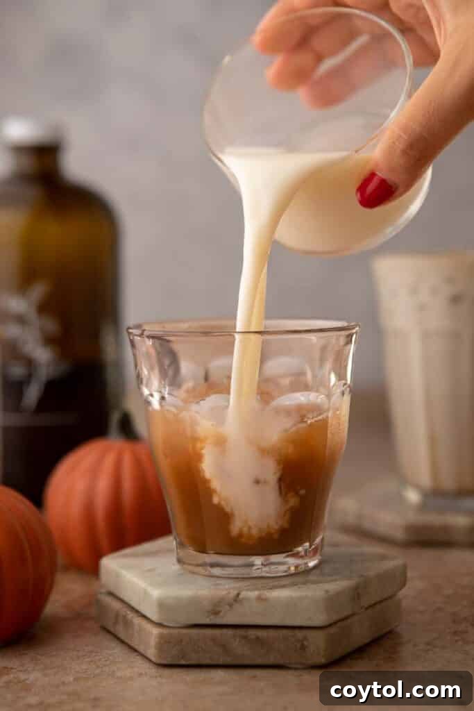 Starbucks' Latest Fall Delight: The Iced Pumpkin Cream Chai Latte 7 Pouring milk over chai concentrate