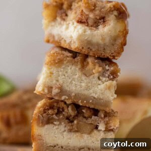 Stack of The best apple cheesecake bars with streusel crisp on top
