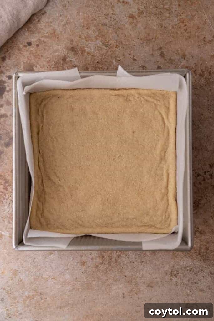 Golden-baked shortbread crust, perfectly set and ready for the next layers of cheesecake and apples.
