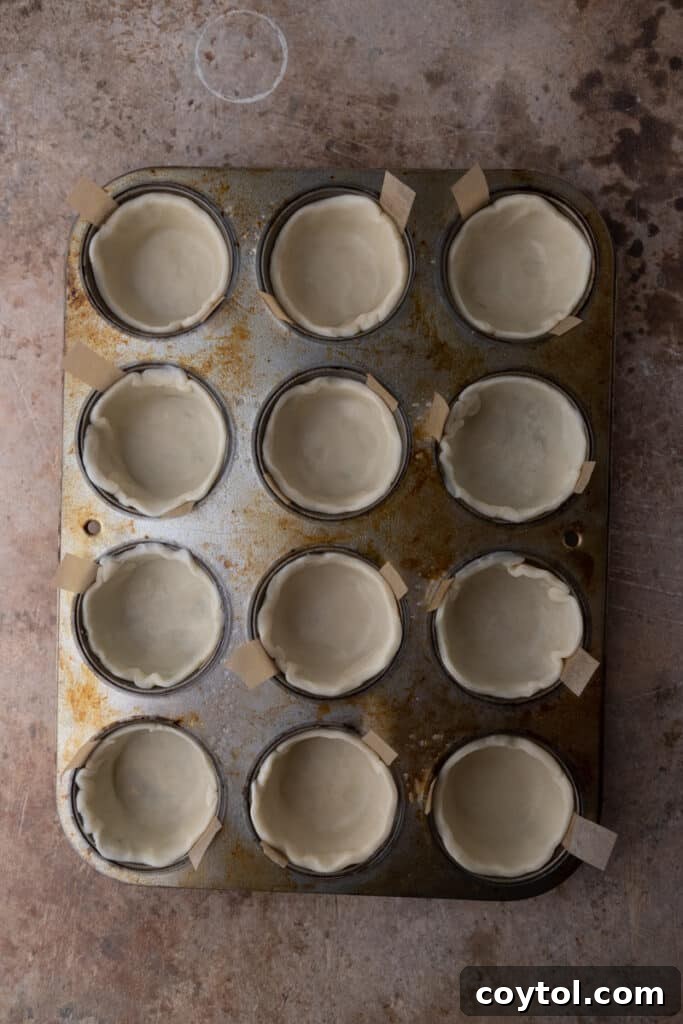 empty pie shells in a muffin tin