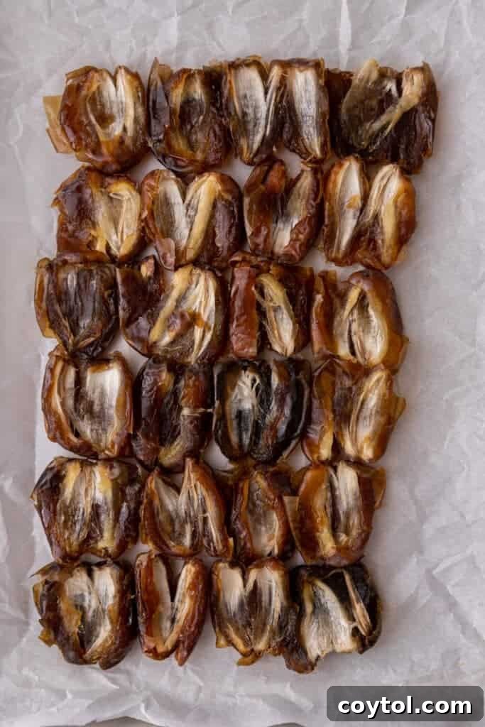 Pitted dates arranged on parchment paper