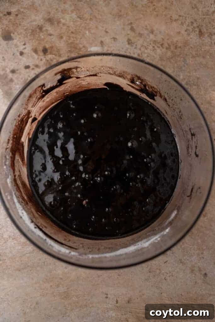 Smooth dark cocoa brownie batter in a mixing bowl.