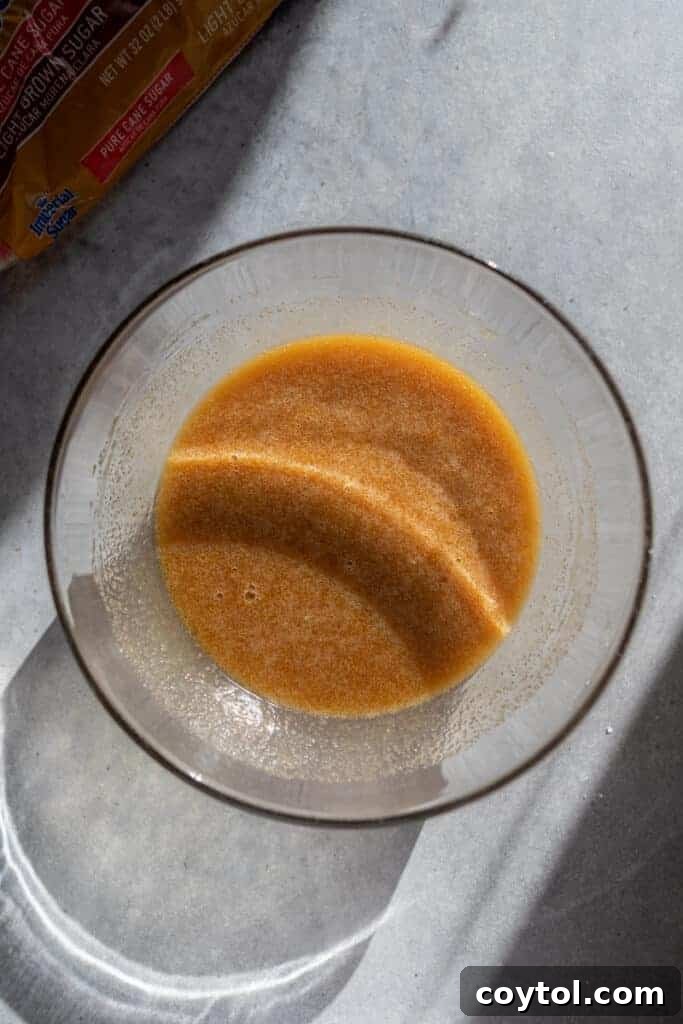 The rich, brown sugar and butter tart filling mixture in a glass bowl, ready to be poured
