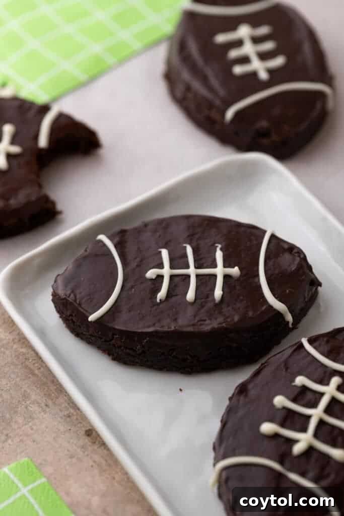 A plate piled high with delicious football-shaped brownies, ready for a game day party.
