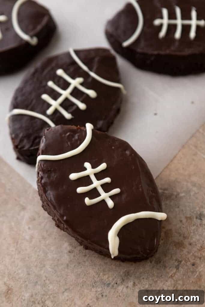Finished football brownies adorned with perfect white chocolate lace designs, ready for game day.