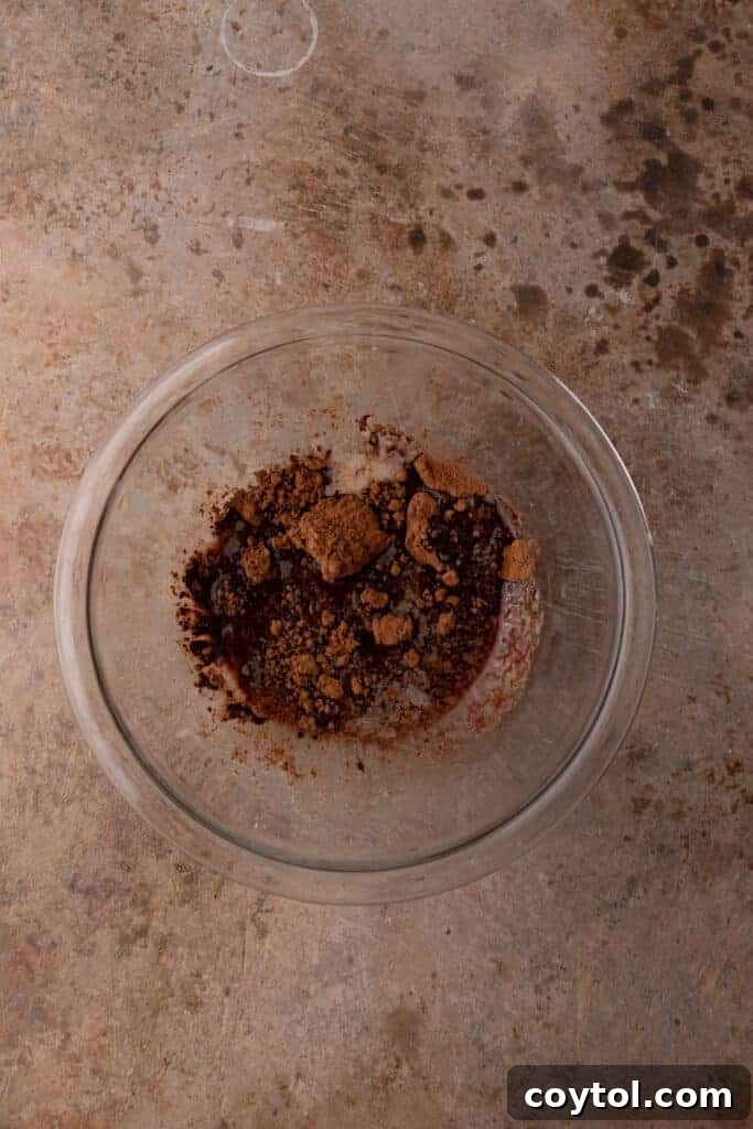 The 4-Minute Frosting Hack for Brownies 8 Melted butter and cocoa powder combined in a bowl, forming the smooth base for the brownie frosting.
