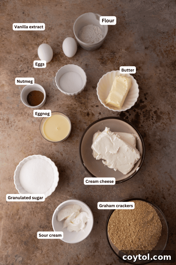 A collection of fresh ingredients laid out for making eggnog cheesecake bars, including cream cheese, eggs, and spices.