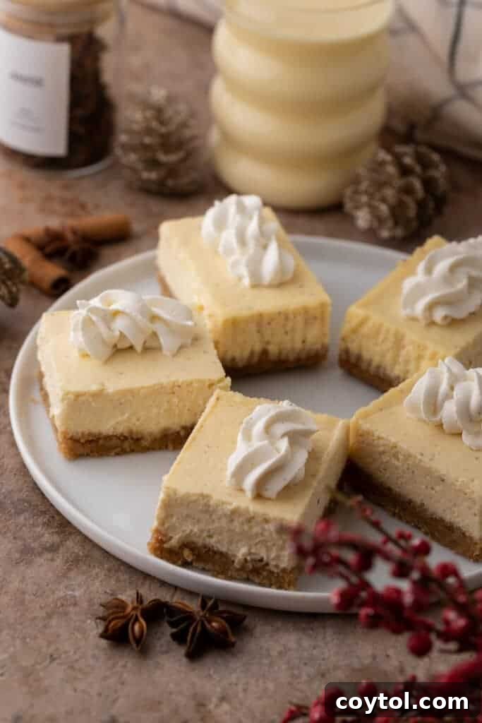 Multiple creamy eggnog cheesecake bars beautifully arranged in a circular pattern, ready for a festive gathering.
