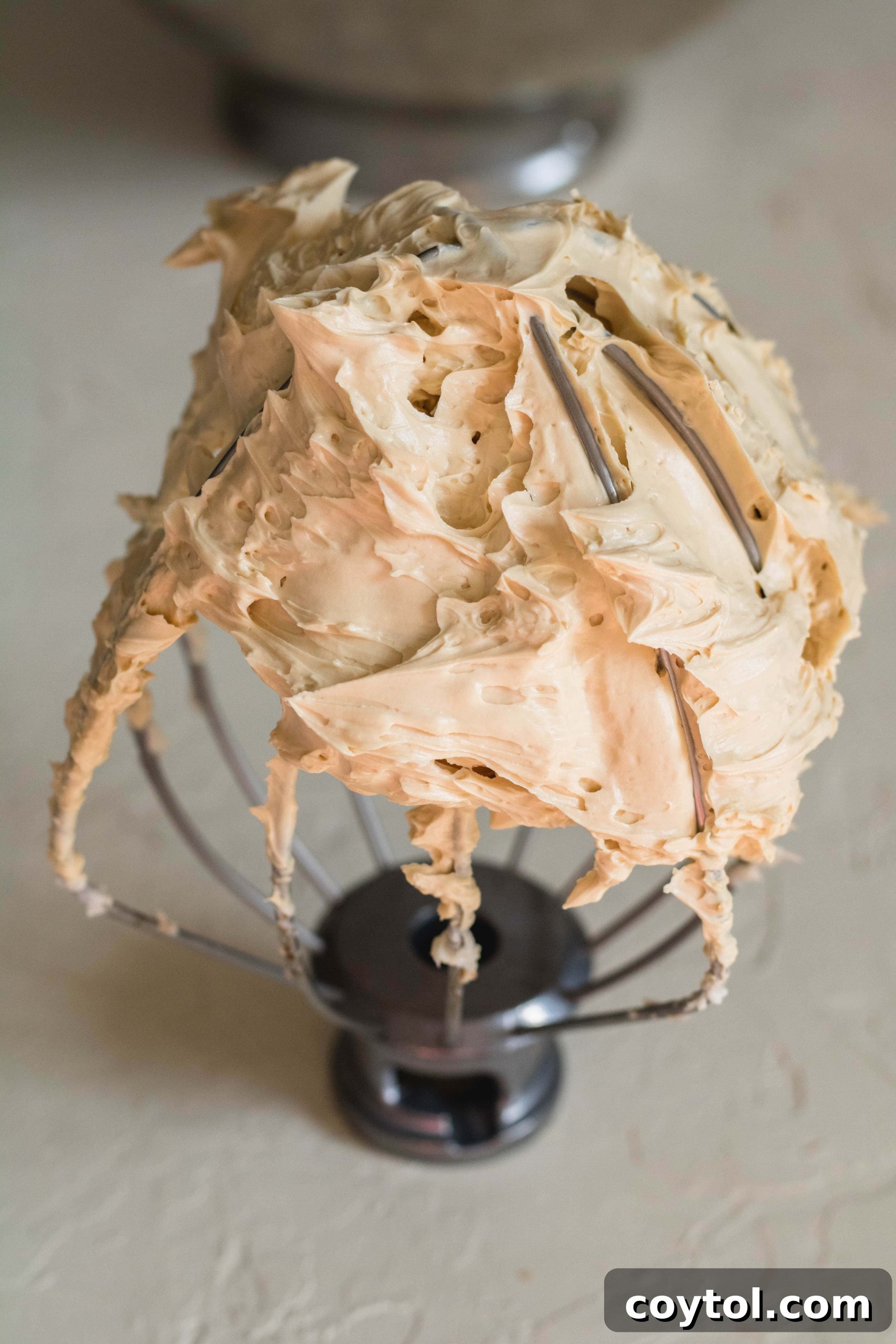 The best coffee frosting recipe ever, beautifully piped and showcasing its rich, golden color.